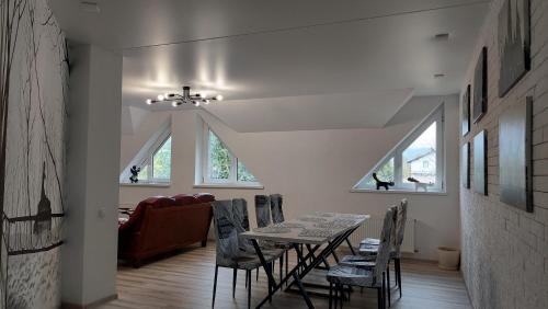 a dining room with a table and chairs at Koteg LEMBERG in Slavske