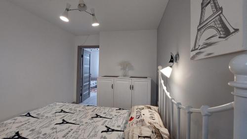 a bedroom with a bed with a comforter on it at Koteg LEMBERG in Slavske