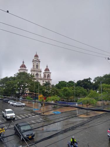 a view of a building with cars parked in a parking lot at Hotel Central Park in Espinal