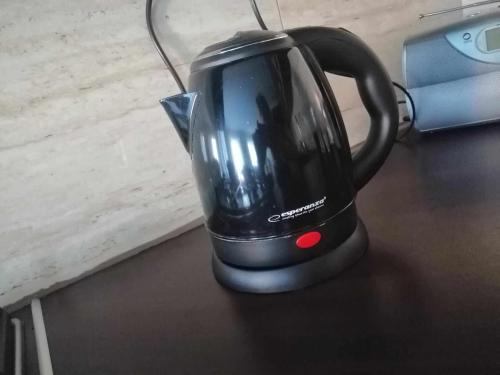 a black tea kettle is sitting on a table at Agroturystyka u podnóża Gór Sowich in Pieszyce