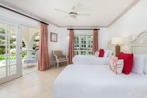 two white beds in a room with a window at Royal Westmoreland - Royal Apartment 214 by Island Villas in Saint James