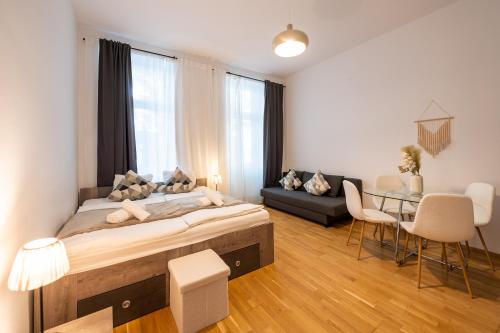 a bedroom with a large bed and a dining room at My city apartment vienna- one Bedroom in Vienna