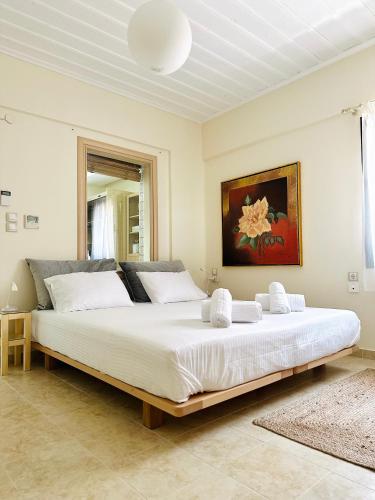 a bedroom with a large white bed in a room at Blueberry Apartments in Parga