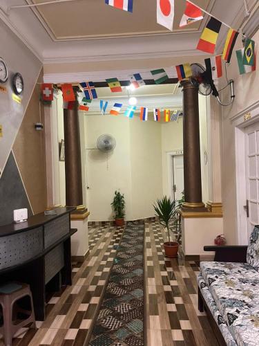 a living room with a piano and flags on the ceiling at New One Hotel in Cairo