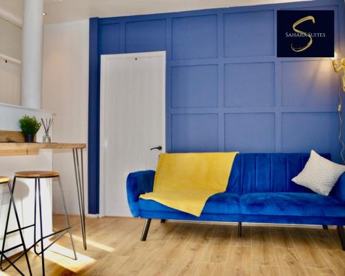 a blue living room with a blue wall and a blue couch at Quirky Modern Two Bedroom Apartment By Sahara Suites Short Lets & Serviced Accommodation Newcastle in Newcastle upon Tyne
