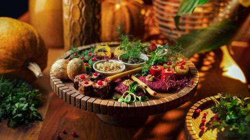 a plate of food sitting on a wooden table at Kass Diamond Resort in Tsalka