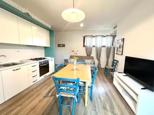 a kitchen with a table and chairs in a room at Vittoria Apartament in Tirrenia