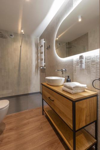 a bathroom with a sink and a mirror at River Side Residence 3/19 in Oświęcim