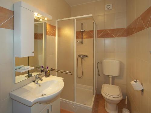 a bathroom with a shower and a sink and a toilet at Apartments Novalja in Novalja