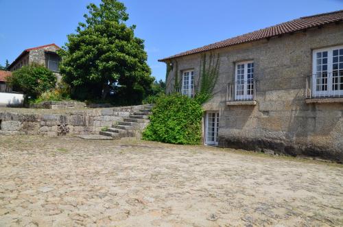 an old stone building with a stone staircase next to it at Casal do Outeiro by LovelyStay in Marco de Canaveses