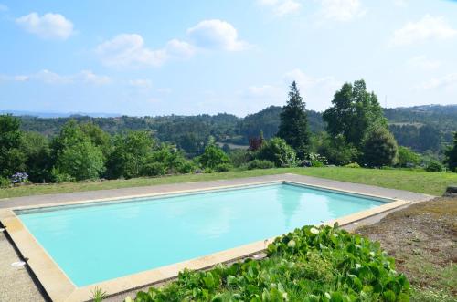 a swimming pool with a view of a field and trees at Casal do Outeiro by LovelyStay in Marco de Canaveses