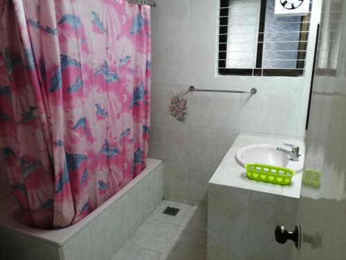 a bathroom with a sink and a shower curtain at Bay Marina Cox's Bazar in Kelātali