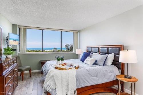 a bedroom with a bed with a view of the ocean at Our House at the Beach W-Tower 5th Fl in Siesta Key