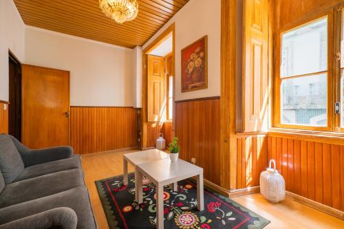 a living room with a couch and a table at Norte Guest House in Lisbon