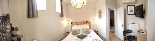 a bedroom with a bed and a room with a lamp at Demeure de la Garenne in Montmirail