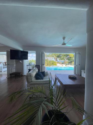 a living room with a couch and a table at ITAKA LOMA BONITA in Las Terrenas