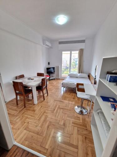 a living room with a table and a bed at EASY ENILION ATHENS CENTER in Athens