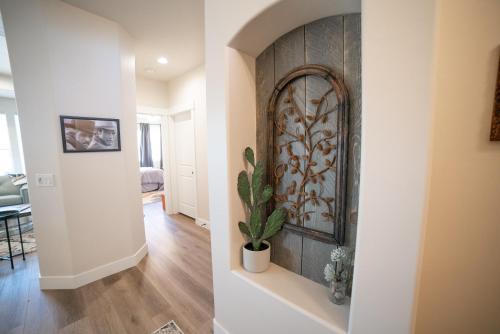 a hallway of a home with a wall with a plant at Hollywood Hangout - New West Properties in Kanab