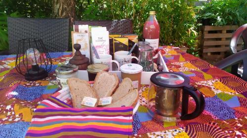 a table with a tray of bread on it at La Villa Bleue in Beauchastel