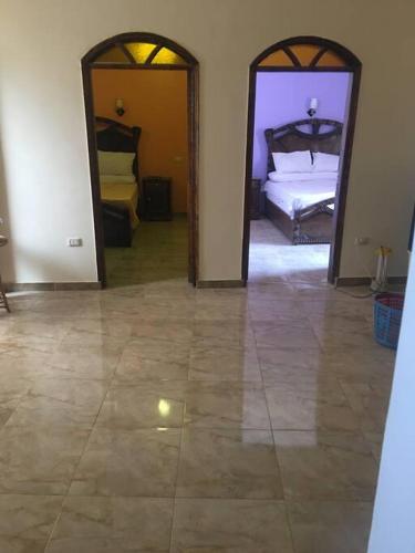 a room with two beds and two mirrors at Tibs mountain view in Al Aqālitah