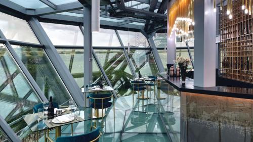 a restaurant with a view of the eiffel tower at Kass Diamond Resort in Tsalka
