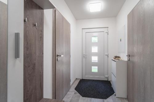 a small hallway with a door and a bathroom at Holiday House Adonis in Bystřice