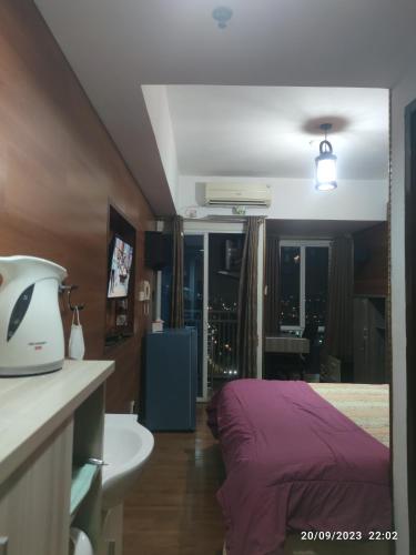 Кровать или кровати в номере Grand Dhika Apartement by 2325 Studio room with cozy wooden style room
