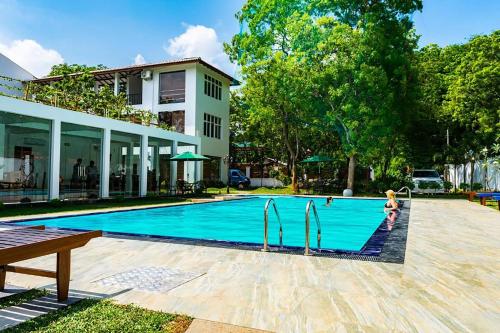 a swimming pool with two people playing in it at Yala Hotel Elephant Eye in Tissamaharama