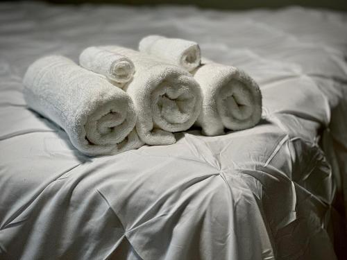 a group of towels sitting on top of a bed at Speedway Legacy Inn in Indianapolis
