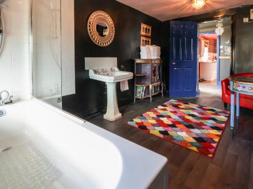 a bathroom with a sink and a blue door at The Funky Flat in Holywell