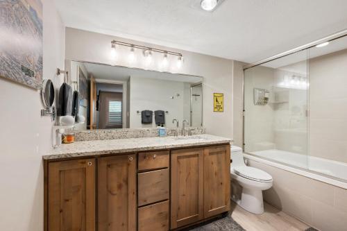 a bathroom with a sink and a toilet and a mirror at Ski-Out Brian Head Condo - Top of Navajo Lift in Brian Head