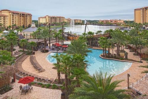 arial view of a resort with a pool and palm trees at Bonnet Creek 2 Bedroom Deluxe in Orlando