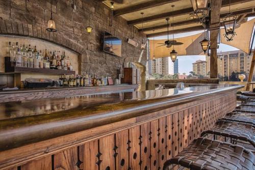 a bar with a long counter and chairs at Bonnet Creek 2 Bedroom Deluxe in Orlando