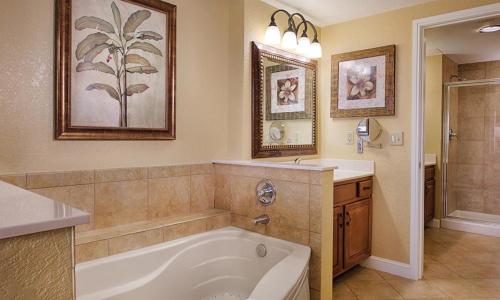 a large bathroom with a tub and a sink at Bonnet Creek 2 Bedroom Deluxe in Orlando
