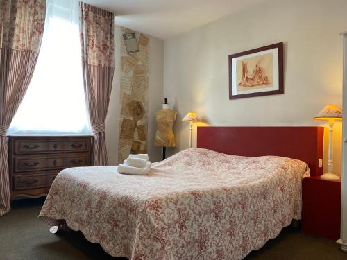 a bedroom with a bed and a window at Hotel Saint Yves in Nantes