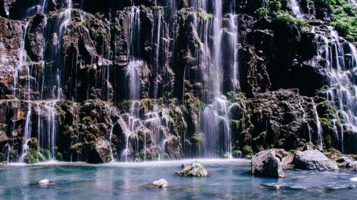 a waterfall in the middle of a pool of water at Kass Diamond Resort in Tsalka