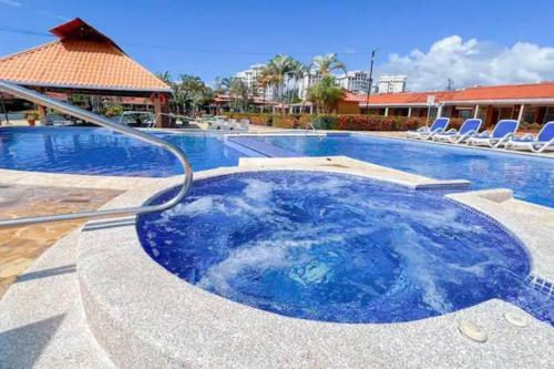 a swimming pool with a hot tub in a resort at Villa Paraíso banano 9, near to the beach & Pool in Jacó