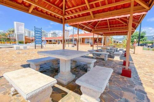 a picnic table under a pavilion in a park at Villa Paraíso banano 9, near to the beach & Pool in Jacó