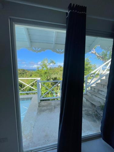 a window with a view of a balcony at ITAKA LOMA BONITA in Las Terrenas