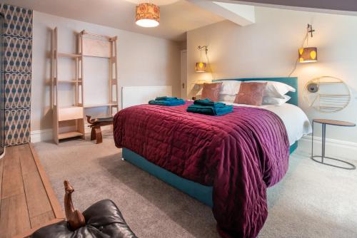 a bedroom with a large bed with a red blanket at Albert Road Apartments Flat 3 in Colne