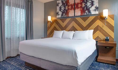 a hotel room with a large bed and a window at Wyndham Glacier Canyon 2 BR in Baraboo