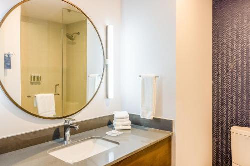 a bathroom with a sink and a mirror at Fairfield by Marriott Inn & Suites Cancun Downtown in Cancún