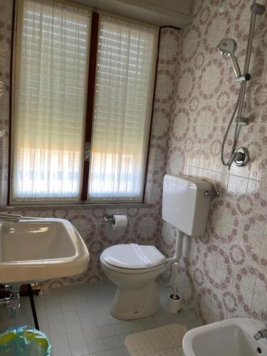 a bathroom with a toilet and a sink at Hotel Stiefel in Lignano Sabbiadoro