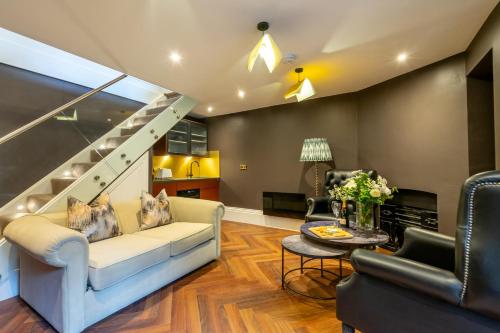 a living room with a couch and a staircase at 34 Coney Street in York