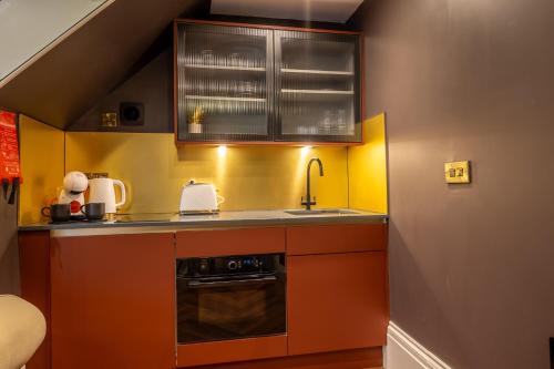 a small kitchen with a sink and a stove at 34 Coney Street in York
