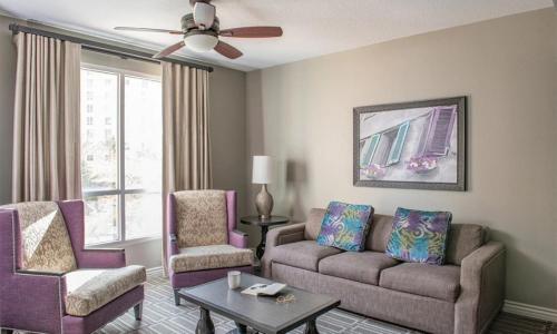 a living room with a couch and two chairs at Wyndham Grand Desert 2 Bedroom in Las Vegas