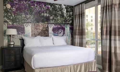 a bedroom with a white bed and a window at Wyndham Grand Desert 2 Bedroom in Las Vegas