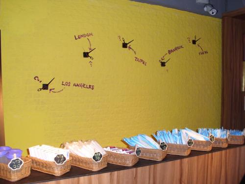 a shelf with wicker baskets on a yellow wall at Backpackers Hostel - Ximen in Taipei