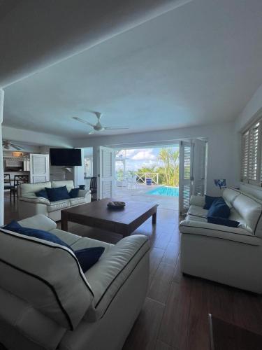a living room with two couches and a table at ITAKA LOMA BONITA in Las Terrenas