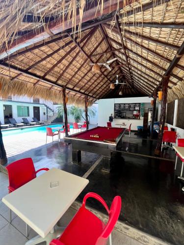 a pool table and ping pong tables in a pavilion with a pool table at Hotel Aqualuna Cyclops in Brisas de Zicatela